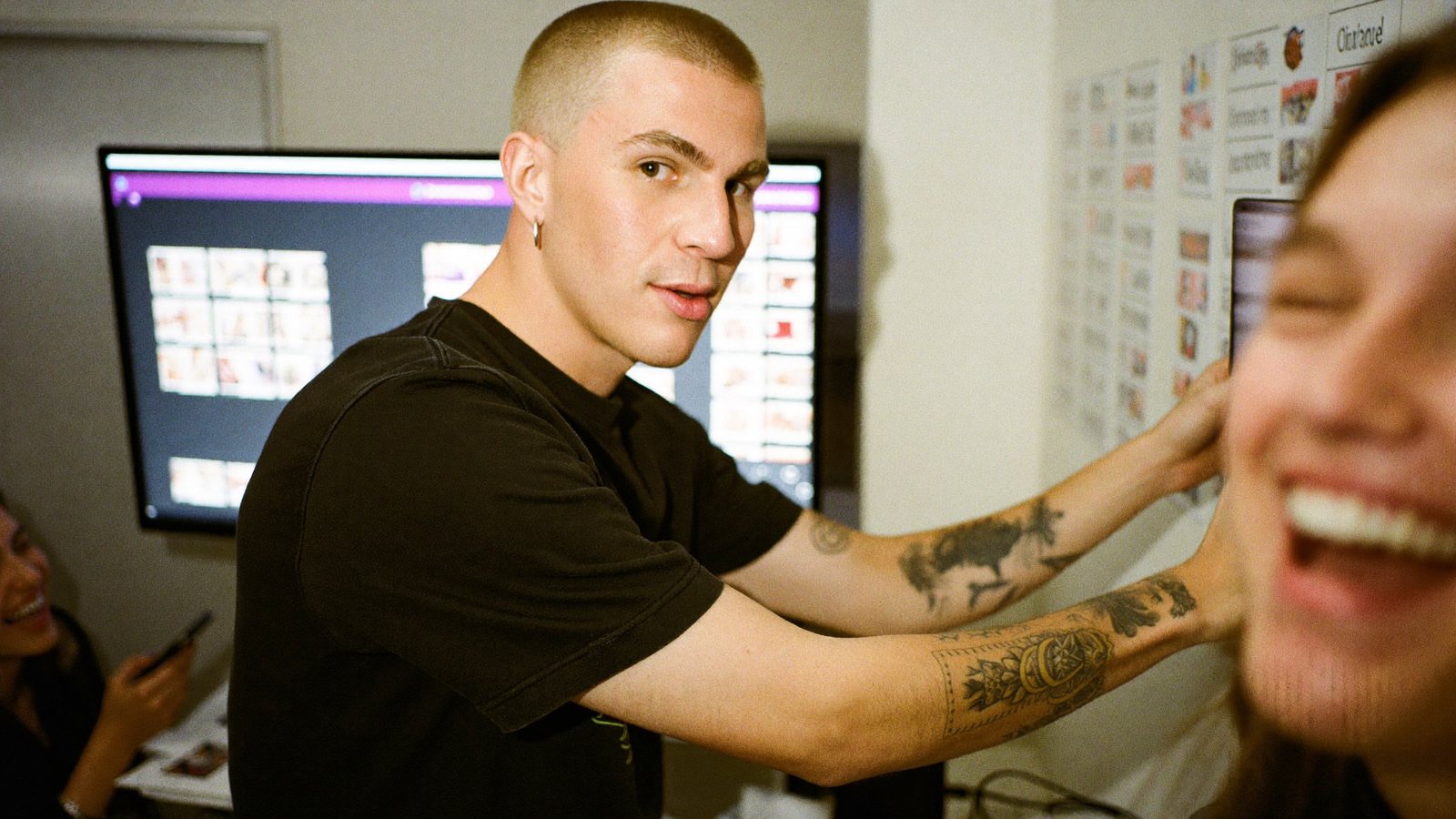 An agency owner directing a row of phones on tripods in a loft studio with an edit bay behind
